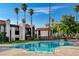 Image displays a community pool with palm trees, alongside clean, modern condominium buildings in the background at 1405 Vegas Valley Dr # 170, Las Vegas, NV 89169