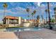 Outside view of a community pool and nearby condo buildings, set with palm trees and desert landscaping at 1405 Vegas Valley Dr # 170, Las Vegas, NV 89169