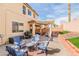 Inviting backyard with a covered patio, outdoor seating, a grill, and well-maintained landscaping at 1422 Ozzie Smith Ave, Henderson, NV 89074