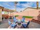 Charming backyard with a pergola, bar seating, and a quaint seating area with a fire pit at 1422 Ozzie Smith Ave, Henderson, NV 89074