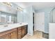 Bright bathroom with double vanity, large mirror, and walk-in shower at 1422 Ozzie Smith Ave, Henderson, NV 89074