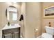 Neutral toned powder room featuring toilet and small sink at 1422 Ozzie Smith Ave, Henderson, NV 89074