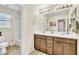 Bathroom with double sink vanity, tile floor and bathtub and shower combo at 1422 Ozzie Smith Ave, Henderson, NV 89074