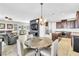 Open-concept dining and living area with modern lighting and spacious seating at 1422 Ozzie Smith Ave, Henderson, NV 89074