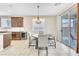 Bright dining area with sliding glass door and stylish chandelier at 1422 Ozzie Smith Ave, Henderson, NV 89074