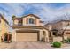 Beautiful two-story home with a stucco exterior, a two-car garage, and a well-manicured front yard at 1422 Ozzie Smith Ave, Henderson, NV 89074