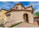 Charming two-story home featuring a stucco exterior, arched entryway, and well-kept landscaping at 1422 Ozzie Smith Ave, Henderson, NV 89074