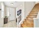 Inviting foyer features tile flooring, a staircase, and a convenient storage cabinet at 1422 Ozzie Smith Ave, Henderson, NV 89074