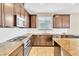 Spacious kitchen features granite countertops, stainless appliances, and rich wood cabinetry at 1422 Ozzie Smith Ave, Henderson, NV 89074