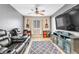 A relaxing living room with a ceiling fan and comfortable leather recliners at 1422 Ozzie Smith Ave, Henderson, NV 89074
