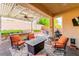 An elegant covered patio with a ceiling fan and cozy outdoor seating arrangement at 1422 Ozzie Smith Ave, Henderson, NV 89074