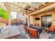 A covered patio features a ceiling fan, outdoor seating, and outdoor kitchen area at 1422 Ozzie Smith Ave, Henderson, NV 89074
