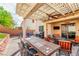 A covered patio features a ceiling fan, outdoor seating, and outdoor kitchen area at 1422 Ozzie Smith Ave, Henderson, NV 89074