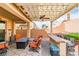 Cozy outdoor patio featuring a pergola with string lights, a fire pit, and comfortable seating at 1422 Ozzie Smith Ave, Henderson, NV 89074