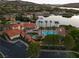 Community pool area with palm trees, lounge chairs, and well-maintained landscaping at 15 Via Mantova # 104, Henderson, NV 89011