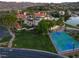 Aerial view highlighting the community's pool, basketball court, and proximity to the lake at 15 Via Mantova # 104, Henderson, NV 89011