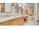 Spacious bathroom with double sinks, marble countertops, soaking tub, and a separate shower at 15 Via Mantova # 104, Henderson, NV 89011