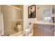A tiled shower, toilet, sink with vanity, and neutral color scheme create a sleek, functional bathroom at 15 Via Mantova # 104, Henderson, NV 89011