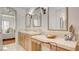 Bathroom featuring double sinks with vanity, granite countertop and an open concept to a bedroom at 15 Via Mantova # 104, Henderson, NV 89011