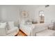 Bright bedroom with white furniture, hardwood floors, and an en-suite bathroom at 15 Via Mantova # 104, Henderson, NV 89011