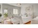 Serene bedroom with white furnishings, decorative wall art, and natural light at 15 Via Mantova # 104, Henderson, NV 89011