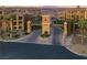 Community entrance gate with manicured landscaping and desert mountain views at 15 Via Mantova # 104, Henderson, NV 89011