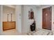 Entryway with decorative tile flooring, a decorative mirror, and custom built-in cabinets at 15 Via Mantova # 104, Henderson, NV 89011