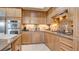 Updated kitchen offering stainless steel appliances, granite counters, and light wood cabinets at 15 Via Mantova # 104, Henderson, NV 89011