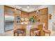 Well-equipped kitchen with stainless steel appliances and a center island with seating at 15 Via Mantova # 104, Henderson, NV 89011