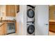 Convenient stacked washer and dryer, in-unit with additional upper cabinet for storage at 15 Via Mantova # 104, Henderson, NV 89011