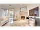Elegant living room showcasing a fireplace, TV, and access to the outdoor patio at 15 Via Mantova # 104, Henderson, NV 89011