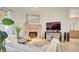 Bright living room featuring a stone fireplace, mirror, and comfortable seating arrangements at 15 Via Mantova # 104, Henderson, NV 89011