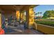 Outdoor patio with seating area overlooking a view of palm trees and lush landscaping at 15 Via Mantova # 104, Henderson, NV 89011