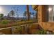 View from patio with vibrant landscaping, trees, and a glimpse of mountain views in the distance at 15 Via Mantova # 104, Henderson, NV 89011