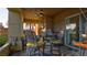 Outdoor patio with a table and chairs, providing a comfortable seating area and nice landscaping at 15 Via Mantova # 104, Henderson, NV 89011