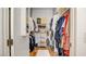 Walk-in closet with custom shelves, ample storage, and hardwood floors at 15 Via Mantova # 104, Henderson, NV 89011