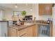 This wet bar includes a sink, wine refrigerator, wood cabinets, and attractive lighting features at 15 Via Mantova # 104, Henderson, NV 89011
