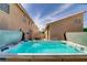 Backyard view featuring a hot tub, patio, landscaping, and neighboring properties at 1730 Juniper Twig Ave, Las Vegas, NV 89183