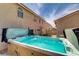 Home backyard featuring a hot tub, patio, landscaping, and neighboring properties at 1730 Juniper Twig Ave, Las Vegas, NV 89183