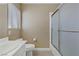 Clean bathroom features a toilet, vanity with sink, and a shower area with a sliding glass door at 1730 Juniper Twig Ave, Las Vegas, NV 89183