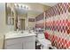 Bright bathroom with a mirror, vanity, toilet, and shower with decorative curtain at 1730 Juniper Twig Ave, Las Vegas, NV 89183