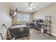 Cozy bedroom with wood floors, ceiling fan, bed with Raiders blanket, and a workspace near the window at 1730 Juniper Twig Ave, Las Vegas, NV 89183