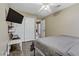 Cozy bedroom features a ceiling fan, closet, and desk area with mounted TV for relaxing and studying at 1730 Juniper Twig Ave, Las Vegas, NV 89183