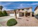 Attractive two-story home features a terracotta roof, complemented by desert landscaping at 1730 Juniper Twig Ave, Las Vegas, NV 89183