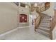 Elegant foyer with a winding staircase and tile flooring, creating a grand entrance at 1730 Juniper Twig Ave, Las Vegas, NV 89183