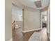 Inviting hallway with wood floors, neutral paint, white trim, and a view of the staircase and bedrooms at 1730 Juniper Twig Ave, Las Vegas, NV 89183
