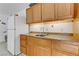 Functional kitchen area with wooden cabinets and a white refrigerator at 1730 Juniper Twig Ave, Las Vegas, NV 89183