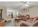 Cozy living room with ceiling fan and comfortable seating, flowing into dining area at 1730 Juniper Twig Ave, Las Vegas, NV 89183