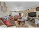Comfortable living room featuring wood-look flooring and a large TV at 1730 Juniper Twig Ave, Las Vegas, NV 89183