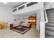 Spacious living space with stairs, cozy seating, kitchenette, and room for dining at 1730 Juniper Twig Ave, Las Vegas, NV 89183